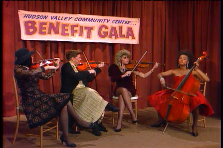 Tootie is very serious on cello while Natalie stifles a laugh with her violin.